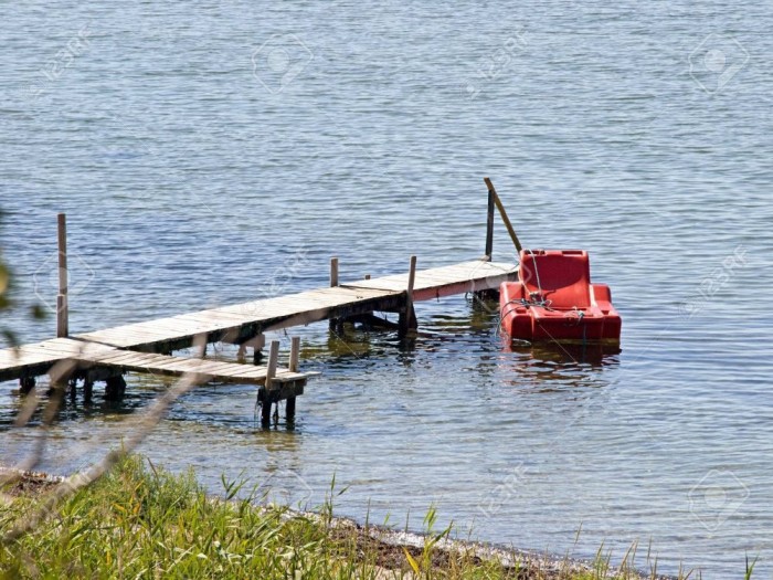 3449008-small-beautiful-wooden-pier-jetty-with-a-floating-armchair.jpg
